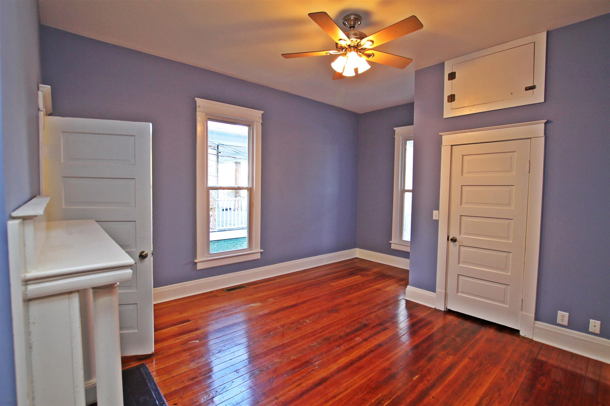 317 North Main Street Springfield, TN 37172 - Photo 18 of 30 an empty room with wooden floor chandelier fan and windows