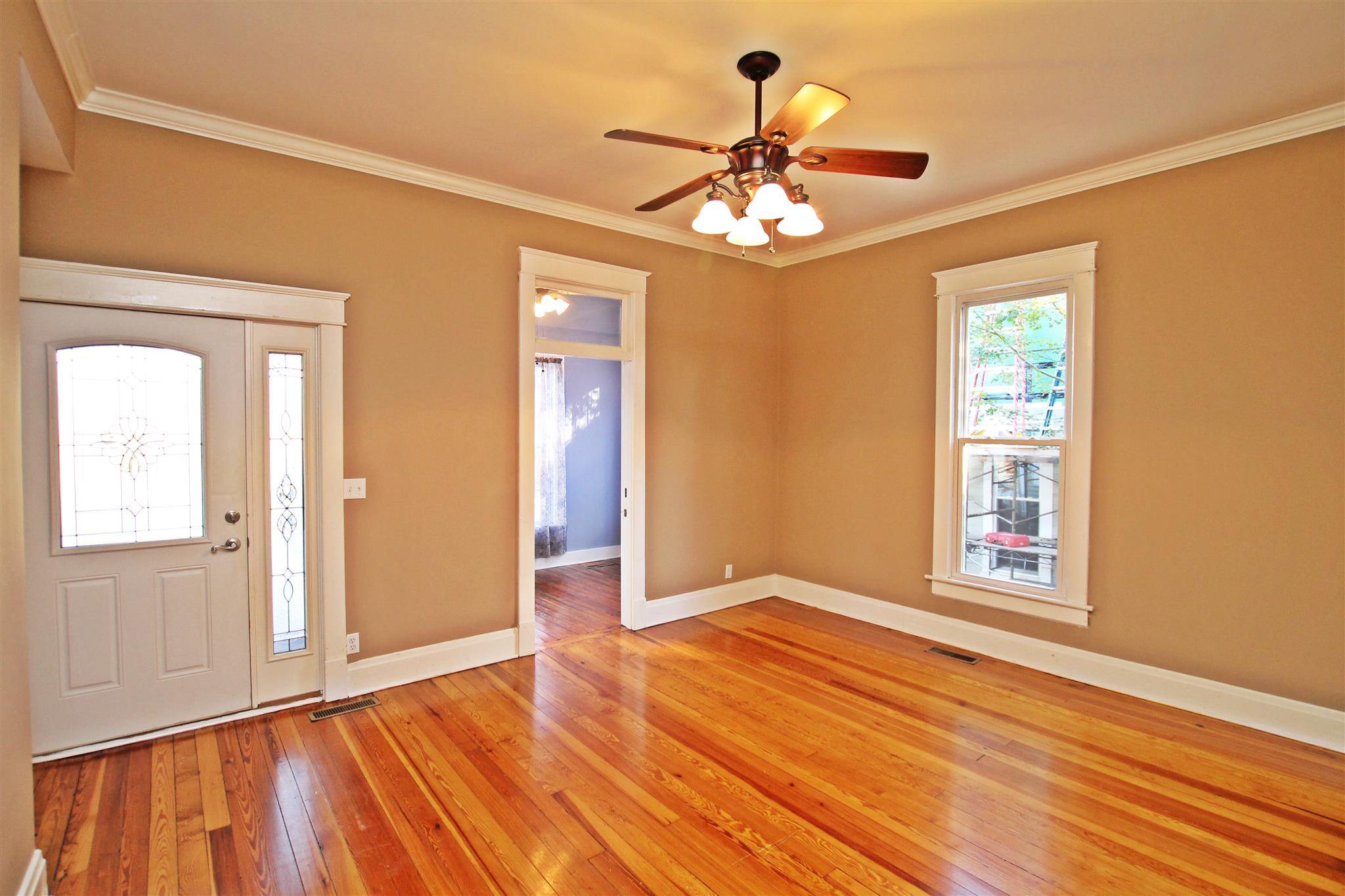 317 North Main Street Springfield, TN 37172 - Photo 4 of 30 a view of an empty room with wooden floor and a window
