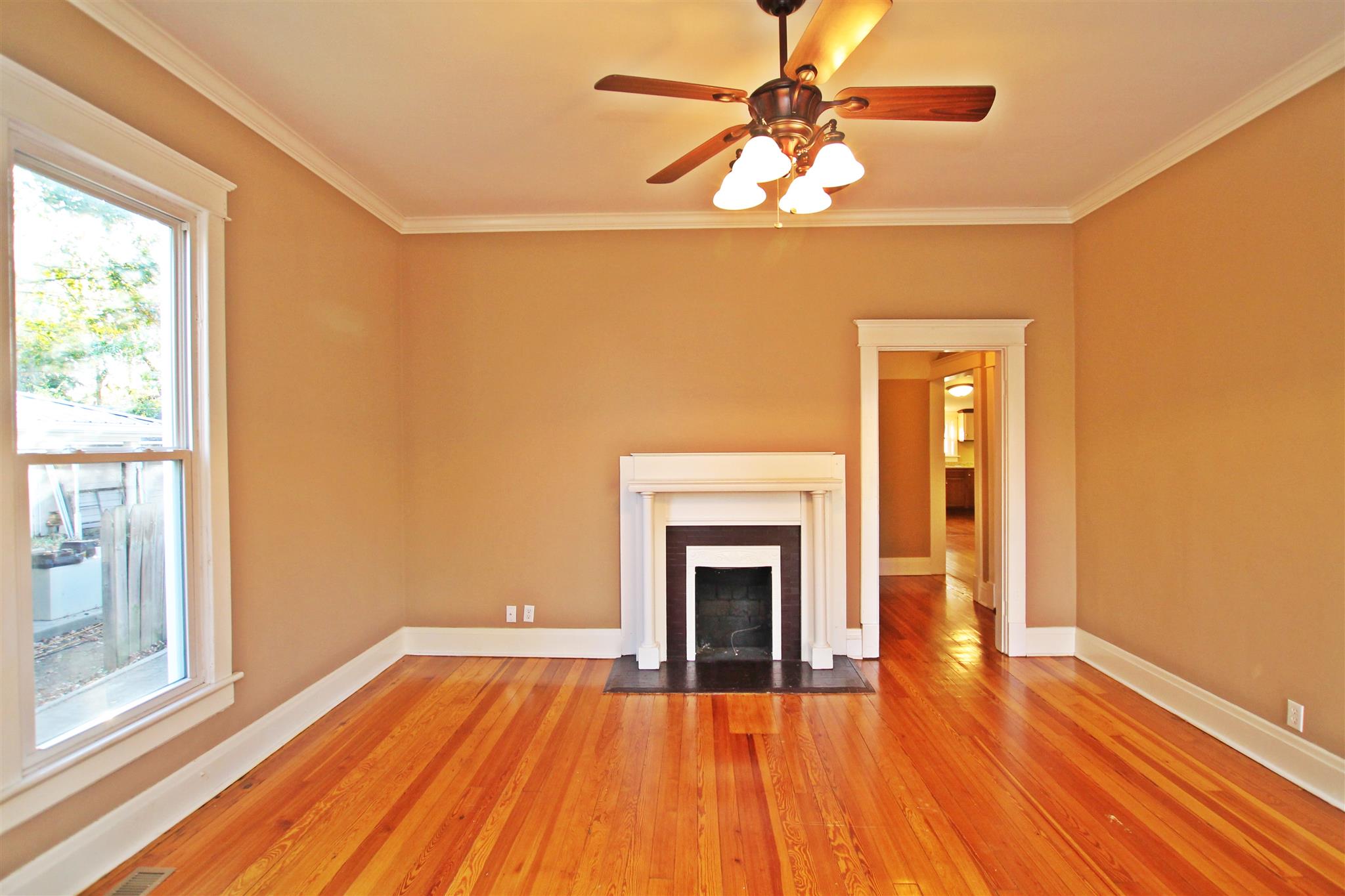 317 North Main Street Springfield, TN 37172 - Photo 6 of 30 a view of empty room with wooden floor and fireplace