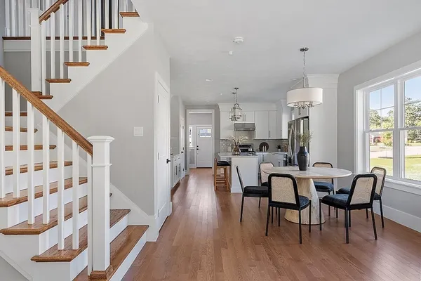 a view of a dining room with furniture and wooden floor