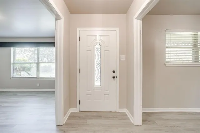 an empty room with windows and closet