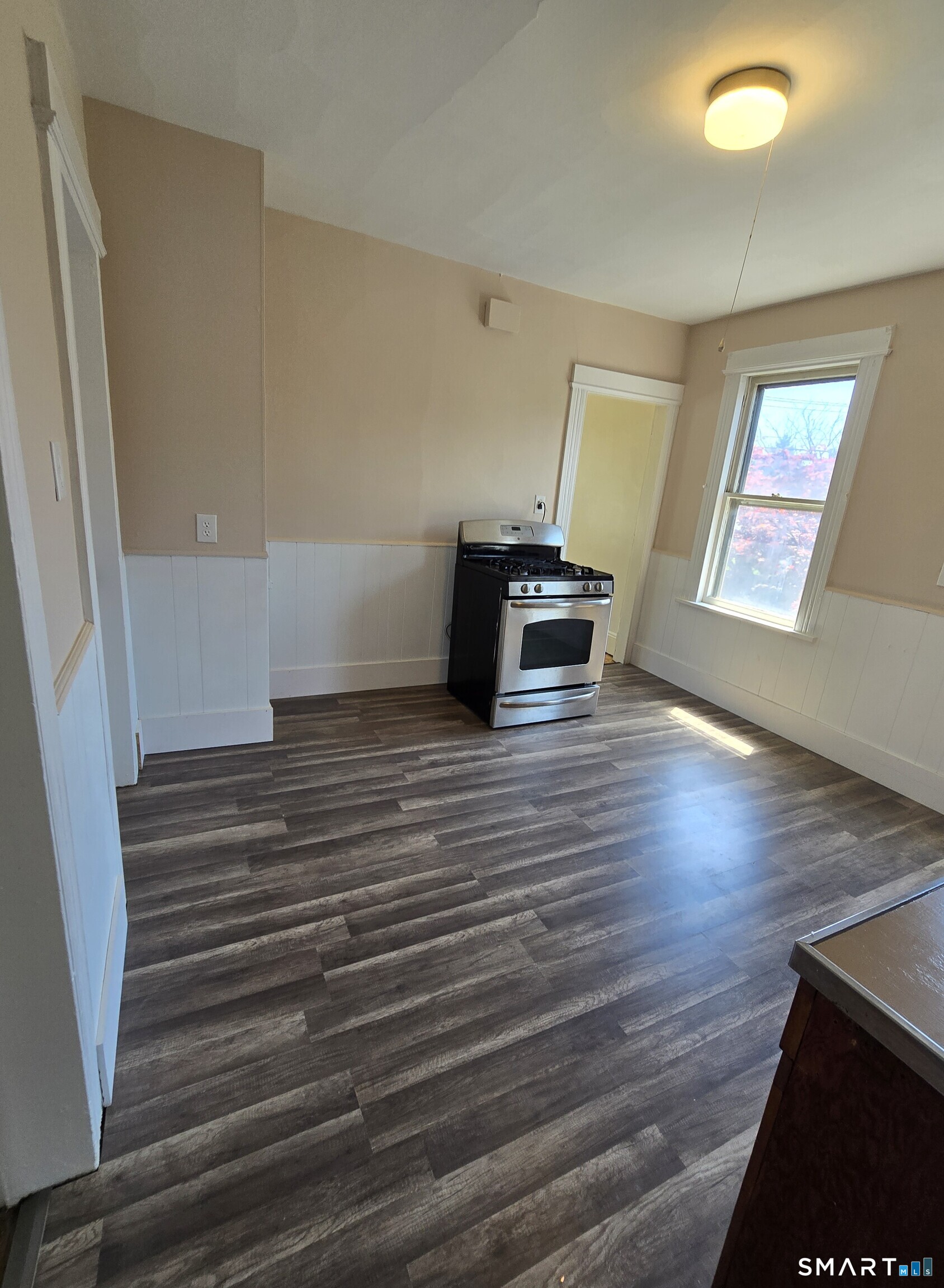 985 Huntington Road Stratford, CT 06614 - Photo 4 of 7 a room with wooden floor and stairs