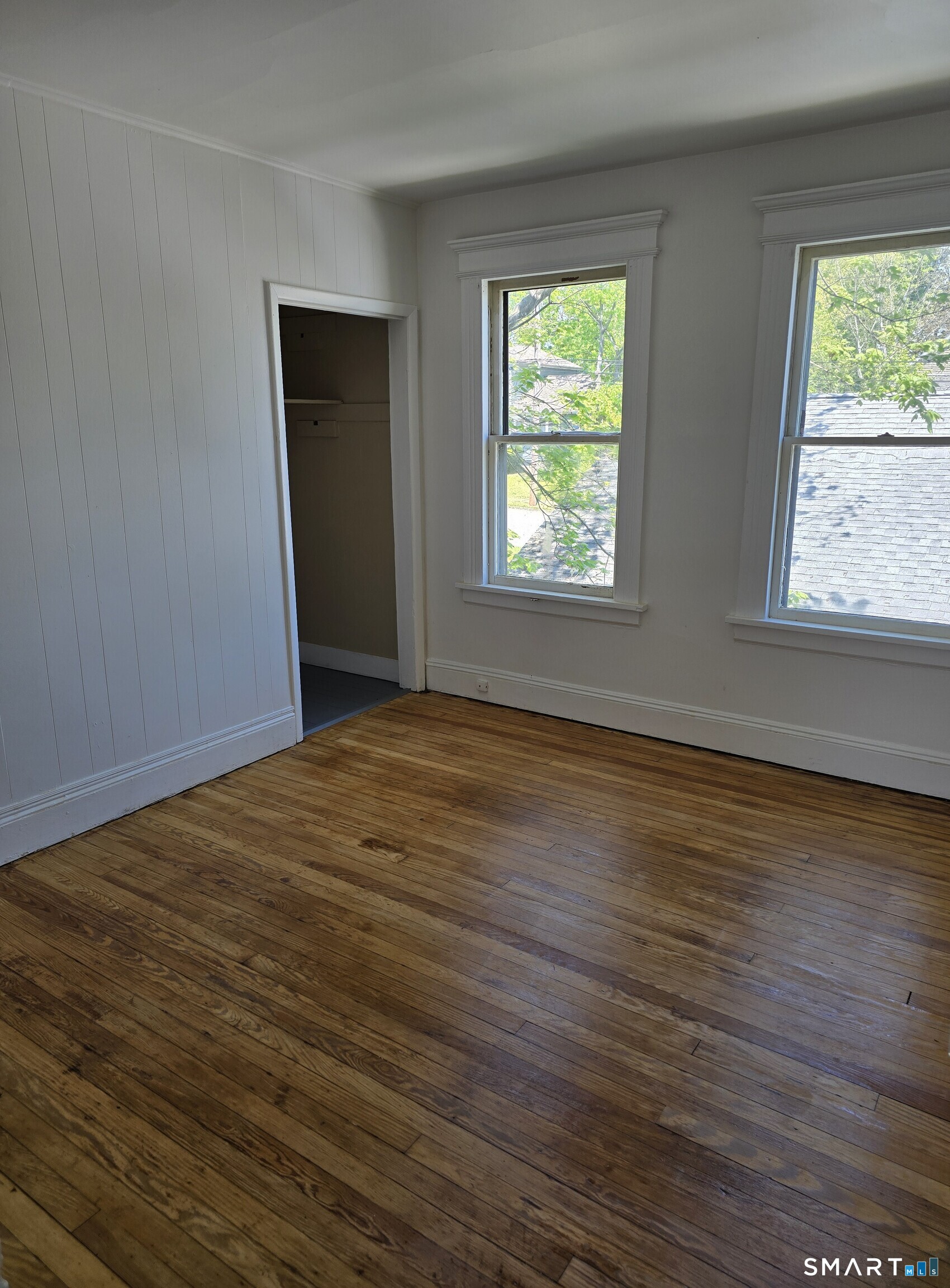 985 Huntington Road Stratford, CT 06614 - Photo 5 of 7 a view of an empty room with wooden floor and a window