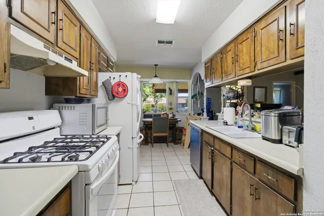a kitchen with stainless steel appliances granite countertop a stove and a sink
