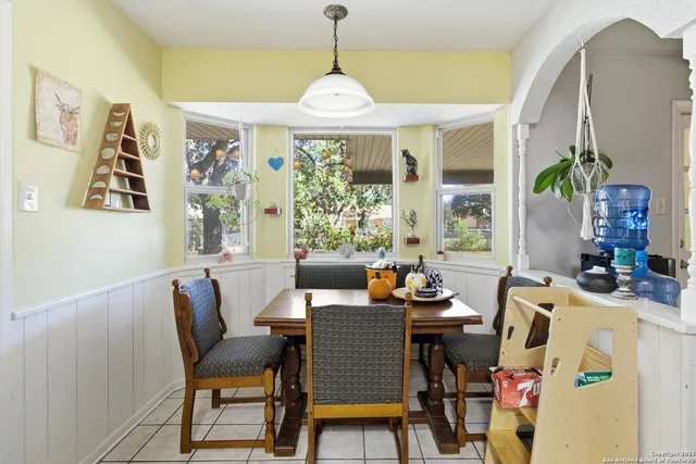a dining room with furniture and window