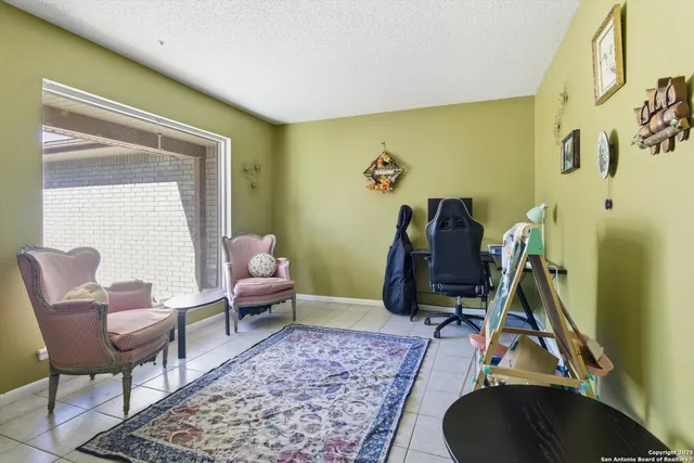 a living room with furniture rug and a window