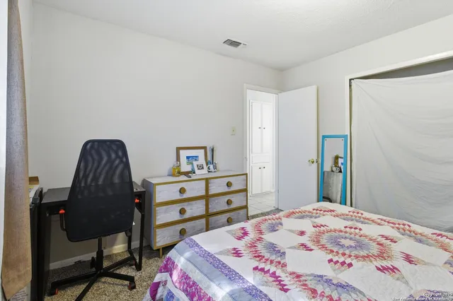 a bedroom with a bed and a dresser in it