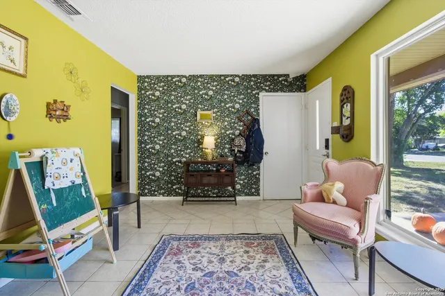 a living room with furniture and a rug