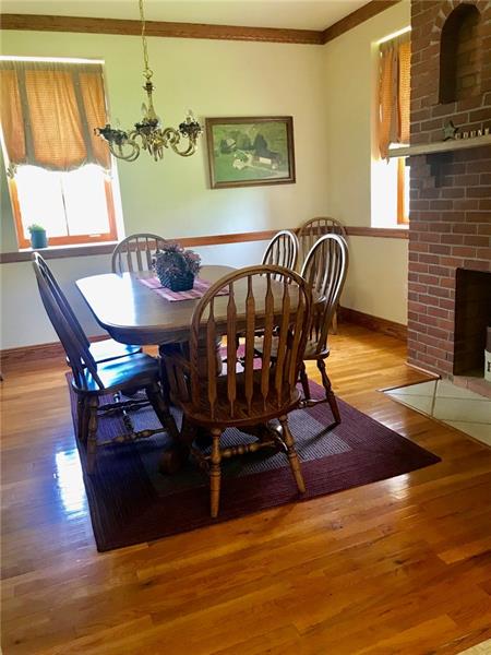 1133 Pine Run Road Apollo, PA 15613 - Photo 11 of 25 Dining room off kitchen has solid hardwood floors and another brick fireplace.