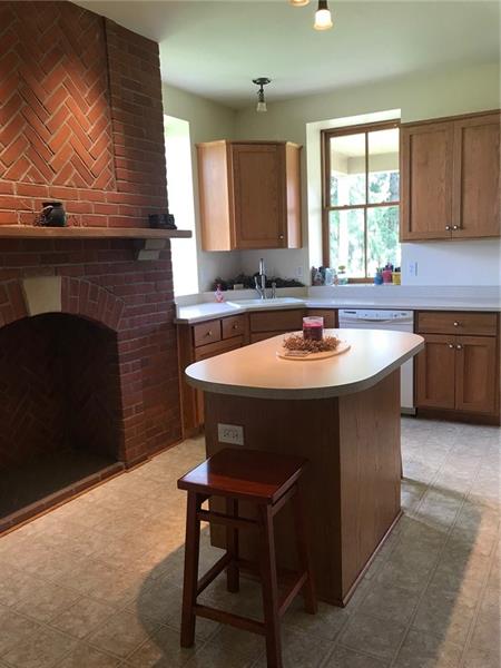 1133 Pine Run Road Apollo, PA 15613 - Photo 7 of 25 Oak cabinets. Custom made with a brick fireplace in the kitchen. All appliances will remain with the home.