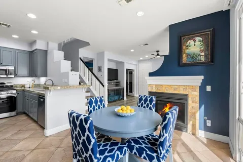 a view of a dining room with furniture and a chandelier