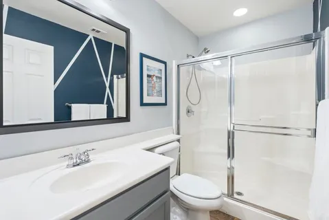 a bathroom with a sink toilet and shower