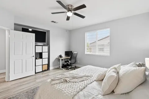 a bedroom with a bed dresser and a window