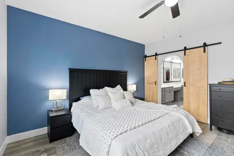 a bedroom with a bed and wooden floor