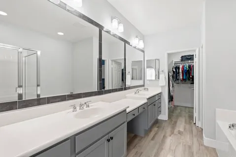 a bathroom with a double vanity sink and mirror