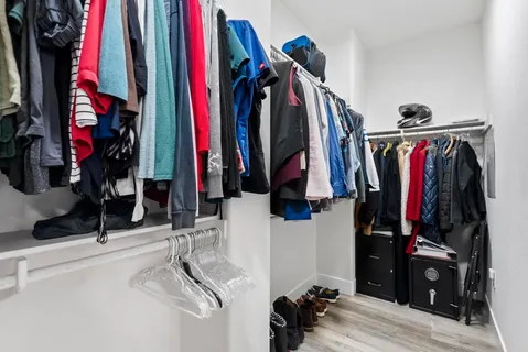 a view of walk in closet with clothes and shoes