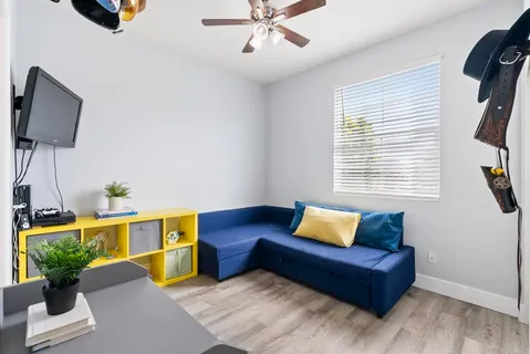 a living room with furniture and wooden floor