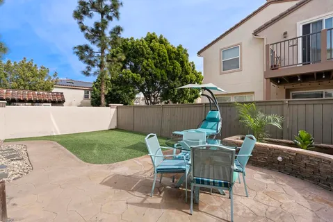 a view of backyard of house with seating space