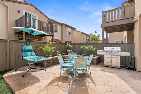 a view of a patio with a dining table and chairs