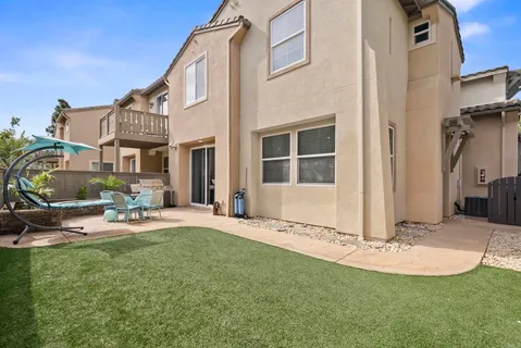 a front view of a house with a garden and patio
