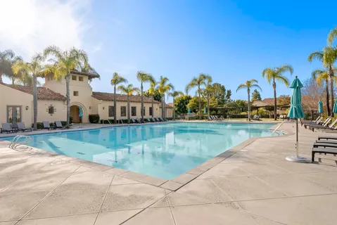 a view of a swimming pool with a yard