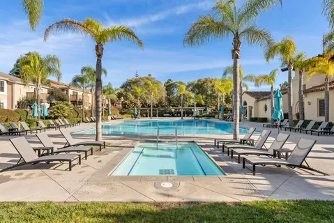 a view of a swimming pool with a lounge chairs