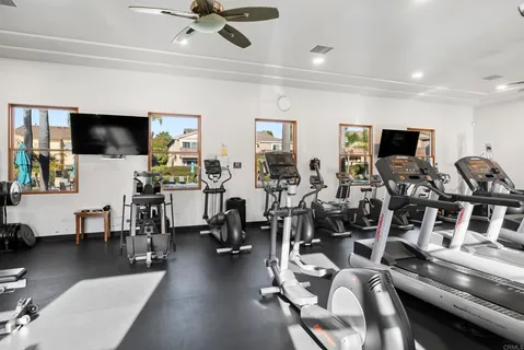 a view of a livingroom with furniture flat screen tv and a large window