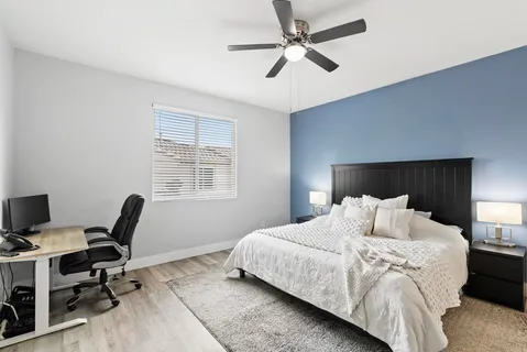 a bedroom with a bed a desk and chair