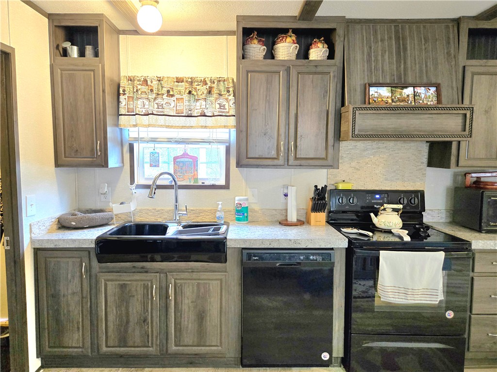 401 Raiders Road Somerville, TX 77879 - Photo 14 of 30 a kitchen with granite countertop a stove a sink and a cabinets