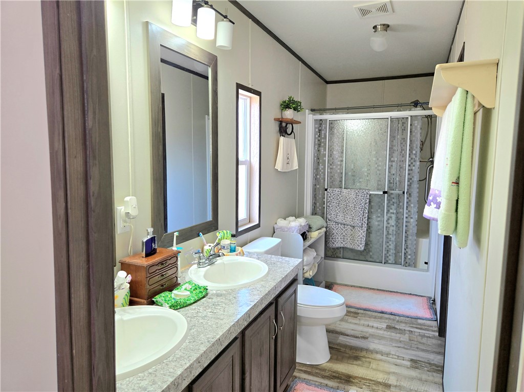 401 Raiders Road Somerville, TX 77879 - Photo 17 of 30 a bathroom with a granite countertop sink toilet and shower