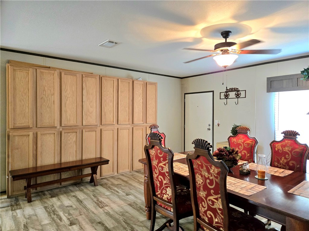 401 Raiders Road Somerville, TX 77879 - Photo 26 of 30 a view of a dining room with furniture and a chandelier