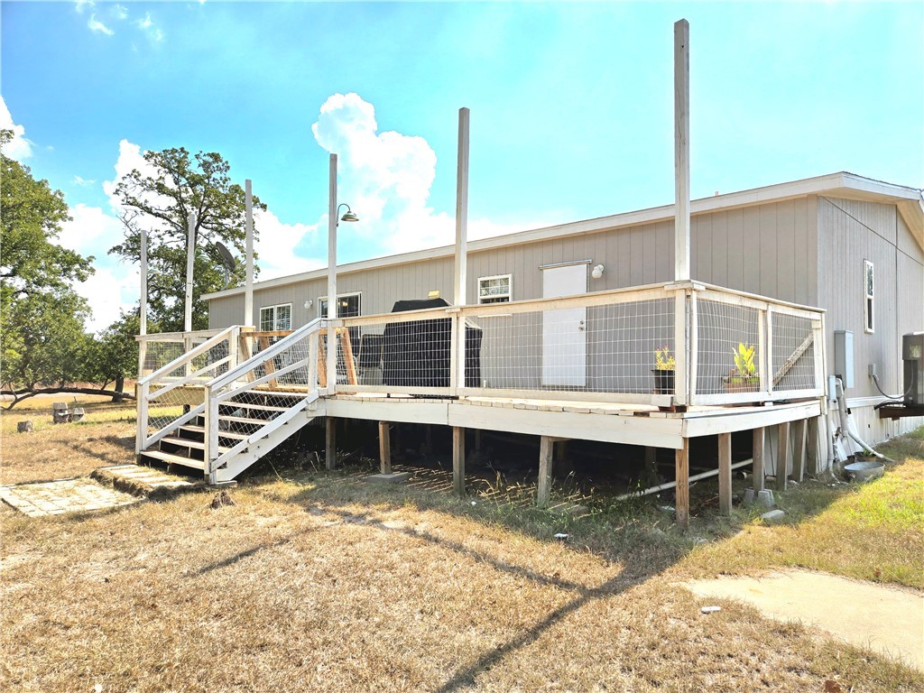 401 Raiders Road Somerville, TX 77879 - Photo 5 of 30 a view of a large white building next to a yard
