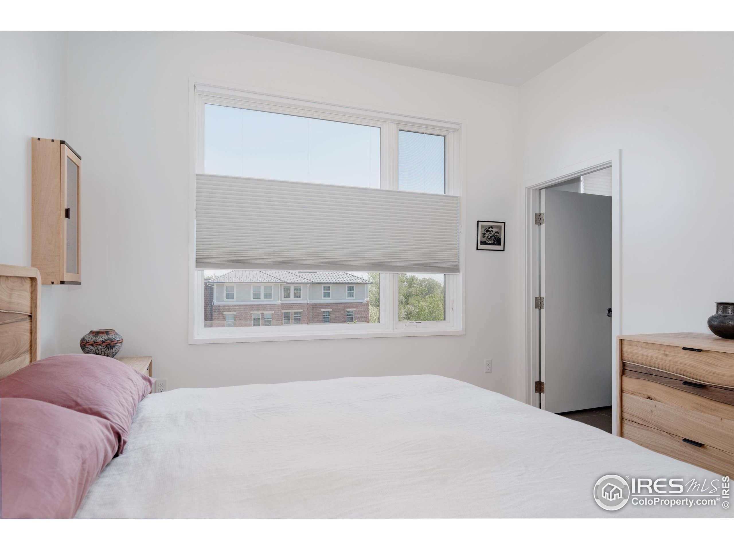 401 Linden Street, Unit 3336 Fort Collins, CO 80524 - Photo 17 of 38 a bedroom with a bed and a window
