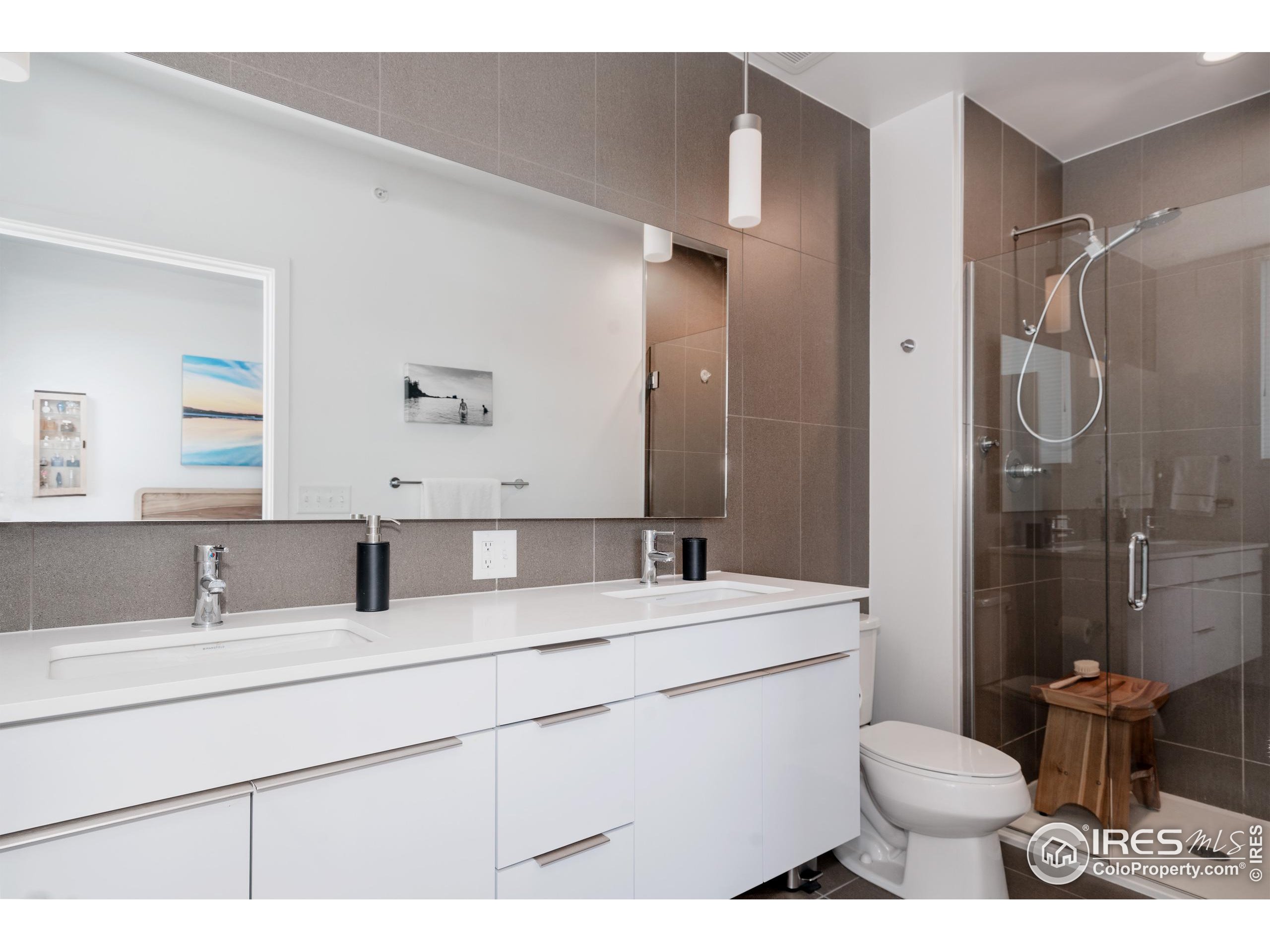 401 Linden Street, Unit 3336 Fort Collins, CO 80524 - Photo 19 of 38 a bathroom with a sink toilet vanity and shower