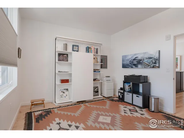 a bedroom with a bed and a bookshelf