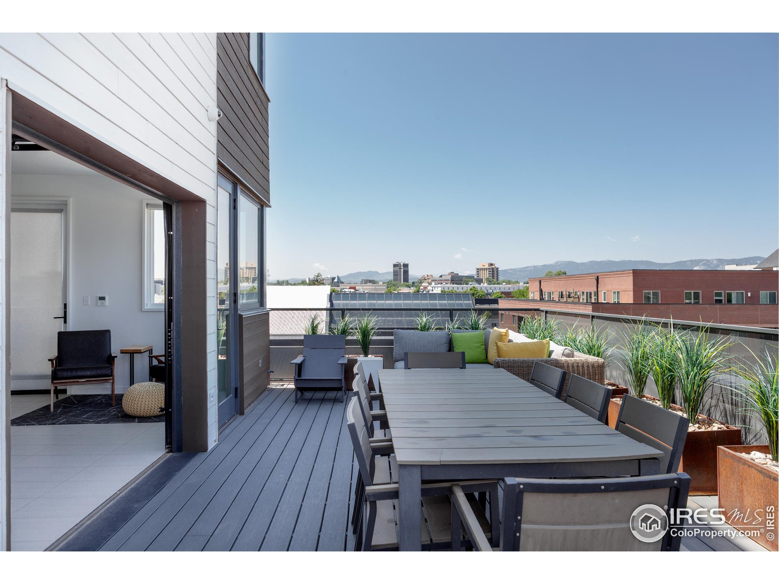 401 Linden Street, Unit 3336 Fort Collins, CO 80524 - Photo 31 of 38 a balcony with wooden floor table and chairs