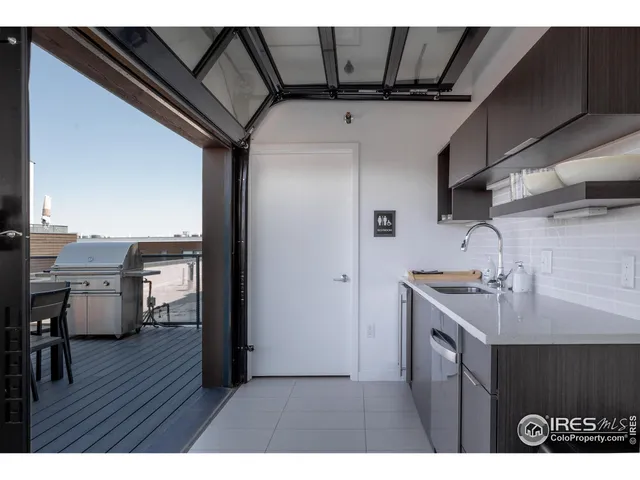 a kitchen with a sink appliances and cabinets