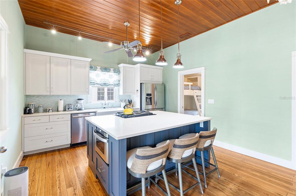 340 Palm Avenue Boca Grande, FL 33921 - Photo 11 of 38 a kitchen with a table chairs and wooden floor