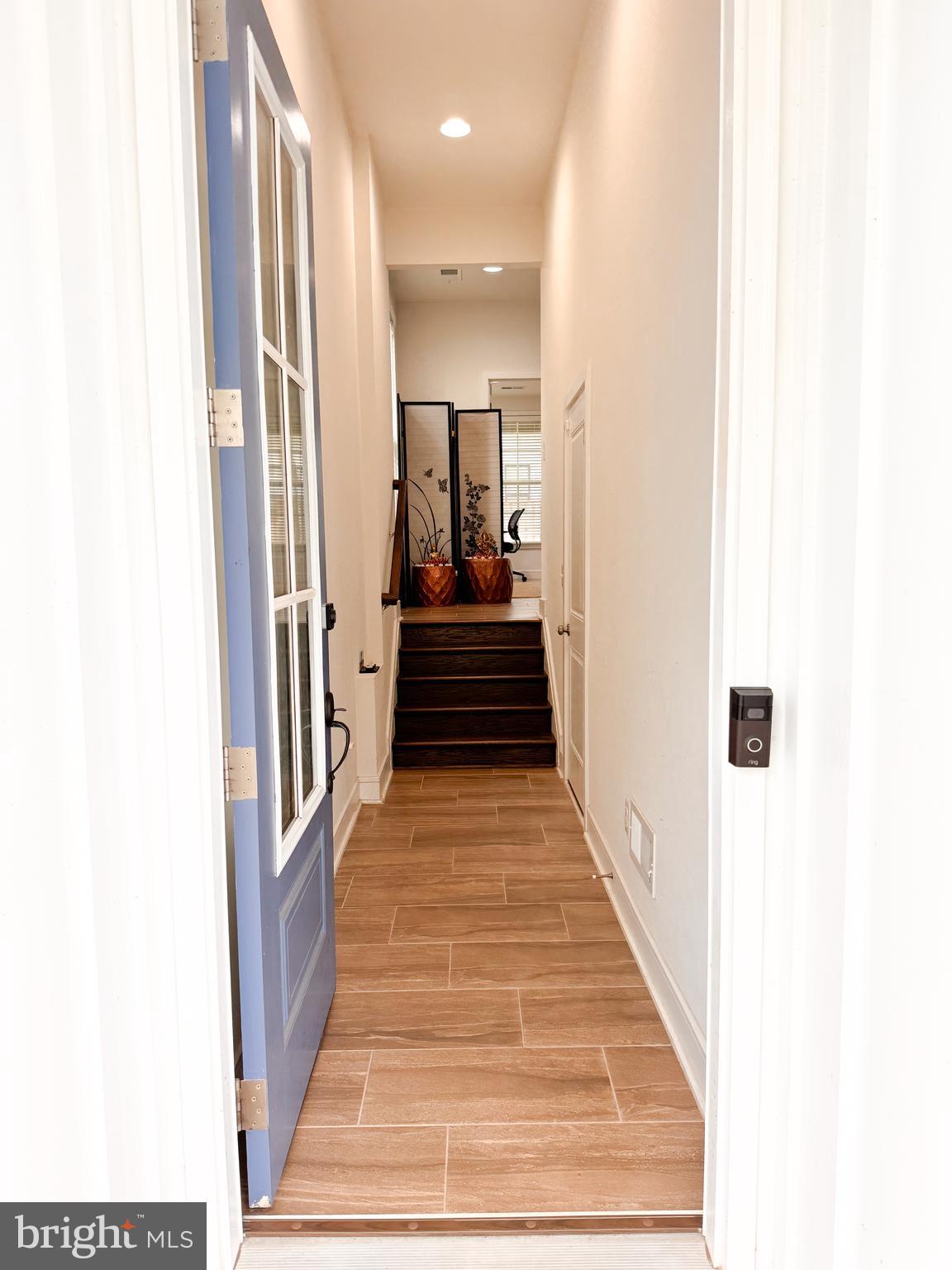 25419 Reed Orchard Terrace Chantilly, VA 20152 - Photo 4 of 47 a view of a hallway with wooden floor and a large window