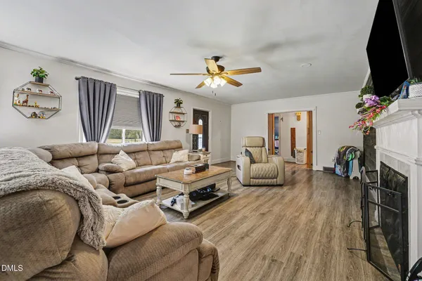 a living room with a fireplace and a flat screen tv
