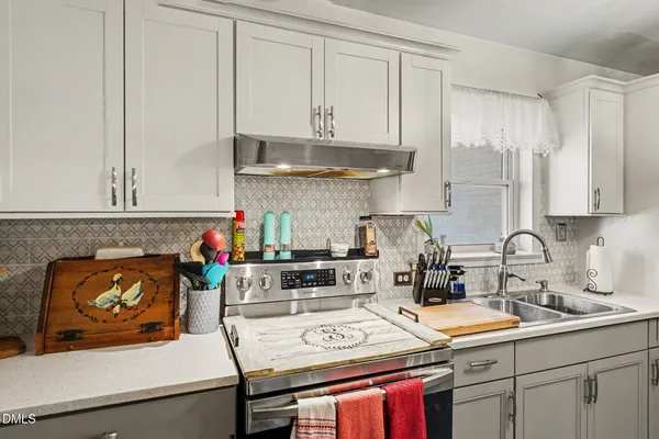 a kitchen with kitchen island wooden cabinets and refrigerator