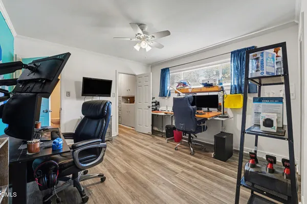 a kitchen with appliances cabinets and wooden floor
