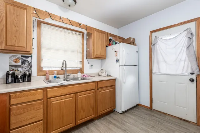 a kitchen with a refrigerator sink and cabinets