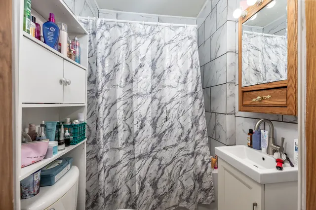 a utility room with a sink and cabinets