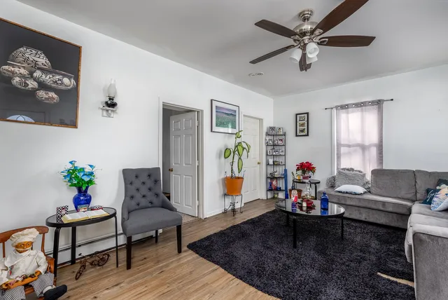 a living room with furniture and wooden floor
