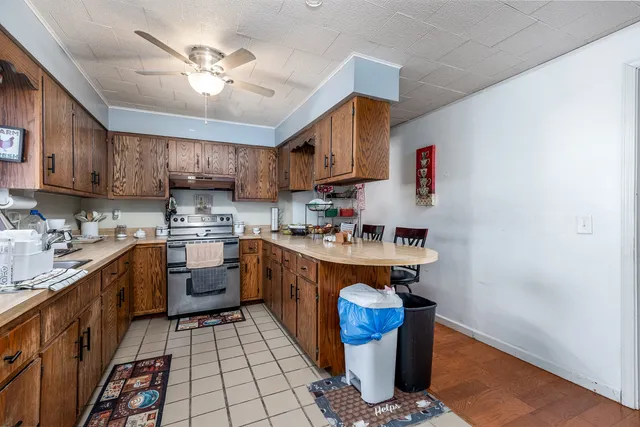 a kitchen with stainless steel appliances granite countertop a sink stove and cabinets