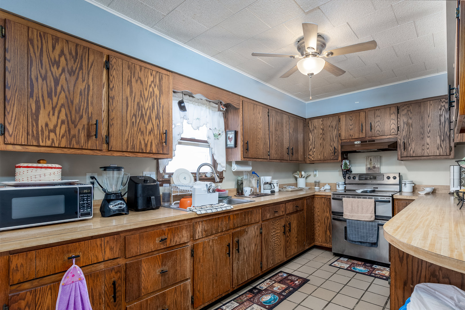 415 North Sycamore Street Somonauk, IL 60552 - Photo 5 of 18 a kitchen with kitchen island granite countertop a sink stainless steel appliances and cabinets