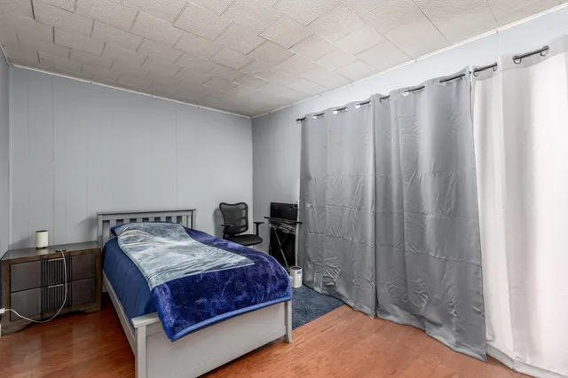 a bedroom with a bed and a mirror