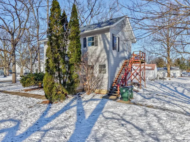 a view of a house with a yard and a tree
