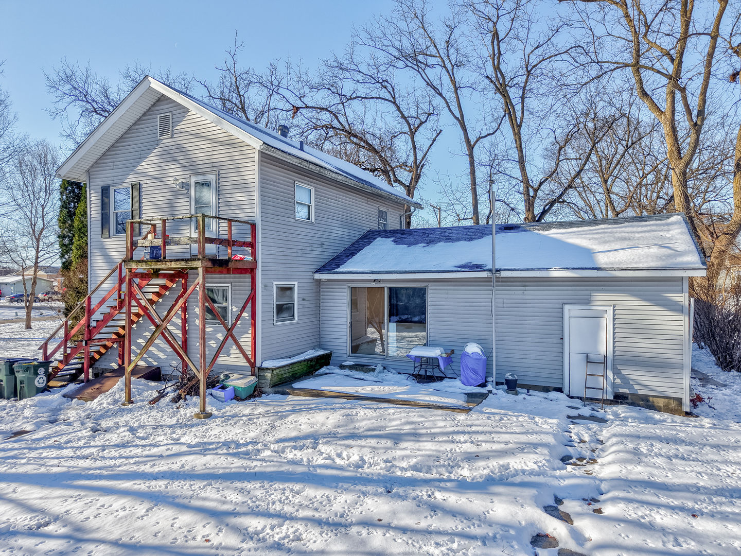 415 North Sycamore Street Somonauk, IL 60552 - Photo 10 of 18 a view of a wooden house with large trees